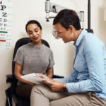 eye doctor discussing with a female patient about her eye sight condition