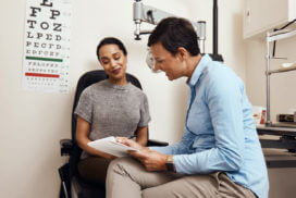 eye doctor discussing with a female patient about her eye sight condition