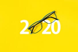 2020 with glasses on yellow isolated background